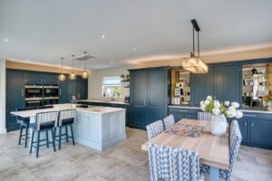 a spacious traditional in frame painted kitchen, with hidden bar area